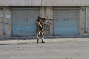 An Afghan security personnel take a position during fighting between Taliban and Afghan security forces in Herat province, west of Kabul, Afghanistan, Tuesday, Aug. 3, 2021.