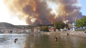 Flames burn on the mountain near Limni village on the island of Evia, about 160 kilometers (100 miles) north of Athens, Greece, Tuesday, Aug. 3, 2021. Greece Tuesday grappled with the worst heatwave in decades that strained the national power supply and fueled wildfires near Athens and elsewhere in southern Greece. As the heat wave scorching the eastern Mediterranean intensified, temperatures reached 42 degrees Celsius (107.6 Fahrenheit) in parts of the Greek capital.