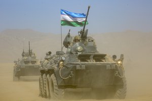 Uzbekistan's armored personnel carriers roll during a joint military drills by Russia, Tajikistan and Uzbekistan at Harb-Maidon firing range about 20 kilometers (about 12 miles) north of the Tajik border with Afghanistan, in Tajikistan, Tuesday, Aug. 10, 2021.