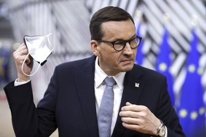 In this Monday, May 24, 2021 file photo, Poland's Prime Minister Mateusz Morawiecki speaks with the media as he arrives for an EU summit at the European Council building in Brussels