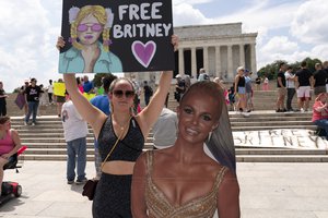 Maggie Howell supporter of pop star Britney Spears protests next to a Britney Spears cardboard cutout at the Lincoln Memorial, during the "Free Britney" rally, Wednesday, July 14, 2021, in Washington