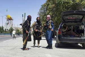 Taliban fighters pose for a photo as they patrol inside the city of Ghazni, southwest of Kabul, Afghanistan, Thursday, Aug. 12, 2021