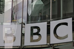 In this Thursday, March 28, 2013 file photo, people looks out from inside BBC's New Broadcasting House, in central London