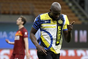 Inter Milan's Romelu Lukaku celebrates after scores the third goal of his team during a Serie A soccer match between Inter Milan and Roma at the San Siro stadium in Milan, Italy, Wednesday, May 12, 2021