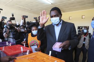 The main opposition presidential candidate, Haikainde Hichilema waves after casting his vote at a polling station in Lusaka, Zambia, Thursday Aug, 12, 2021