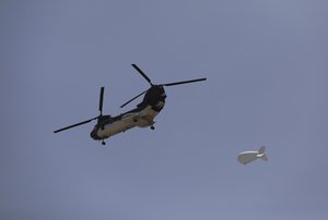 File photo: A U.S. Chinook helicopter flies over the city of Kabul, Afghanistan, Sunday, Aug. 15, 2021. Taliban fighters entered the outskirts of the Afghan capital on Sunday