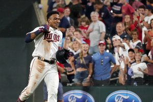 Minnesota Twins Jorge Polanco races to the dugout after his walk-off single drove in the winning run in the 10th inning of a baseball game against the Cleveland Indians