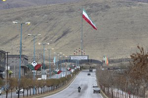 Iran's flag waves at the entrance of Absard, the town where Mohsen Fakhrizadeh, an Iranian scientist linked to the country's nuclear program was killed by unknown assailants last month, east of the capital, Tehran, Iran, Wednesday, Dec. 16, 2020.