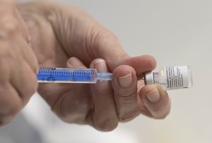 A medical worker fills a syringe with a dose of the Pfizer-BioNTech Covid-19 disease vaccine at the corona vaccination centre at the Robert Bosch hospital in Stuttgart, Germany