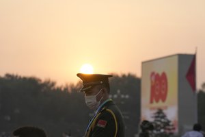 A People's Liberation Army solder stands during a rehearsal for a ceremony to mark the 100th anniversary of the founding of the ruling Chinese Communist Party at Tiananmen Gate in Beijing Thursday, July 1, 2021