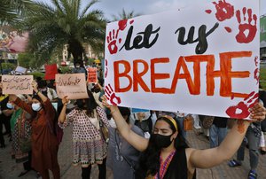 Women's rights activist take part in a demonstration to condemn the violence against women, in Lahore, Pakistan, Saturday, July 24, 2021.