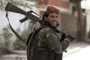 A Taliban fighter patrols in Wazir Akbar Khan in the city of Kabul, Afghanistan, Wednesday, Aug. 18, 2021