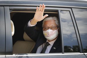 Former Deputy Prime Minister Ismail Sabri Yaakob waves to media as he leave after meeting with the King at national palace in Kuala Lumpur, Malaysia, Thursday, Aug. 19, 2021