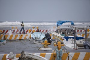 A fisherman talks on his phone in the Veracruz state of Mexico, Friday, Aug. 20, 2021