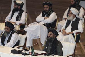 Taliban co-founder Mullah Abdul Ghani Baradar speaks, bottom right, talks at the opening session of the peace talks between the Afghan government and the Taliban in Doha, Qatar, Saturday, Sept. 12, 2020