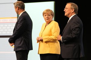 Armin Laschet, the center-right Union bloc's candidate for chancellor in Germany's September election, right, outgoing Chancellor Angela Merkel, center, and Christian Social Union party leader Markus Soeder arrive for an event kicking off the conservatives' official election campaign