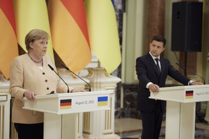 Ukrainian President Volodymyr Zelenskyy, right, and German Chancellor Angela Merkel attend a joint news conference following their talks at the Mariinsky palace in Kyiv, Ukraine, Sunday, Aug. 22, 2021