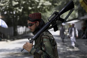 A Taliban fighter stands guard at a checkpoint in the Wazir Akbar Khan neighborhood in the city of Kabul, Afghanistan, Sunday, Aug. 22, 2021