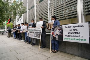 Afghan interpreters protest holding placards outside the Home Office, in London, Monday, Aug. 23, 2021.