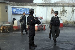 Afghan security forces gather at the site of a suicide bomber and gunmen attack a day after in Kabul, Afghanistan, Tuesday, Dec. 25, 2018.