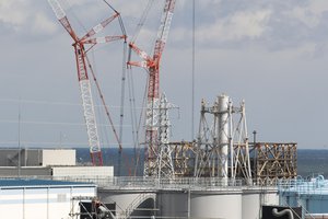 This photo shows the damaged Unit 1 reactor, back, and part of the exhaust stack shared with the Unit 1 and 2 reactors at the Fukushima Daiichi nuclear power plant in Okuma town, Fukushima prefecture, northeastern Japan, Saturday, Feb. 27, 2021. The Pacific Ocean is seen in the background.