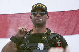 In this Sept. 26, 2020, file photo, Proud Boys leader Henry "Enrique" Tarrio wears a hat that says The War Boys during a rally in Portland, Ore. Tarrio, has been sentenced to five months in jail. Tarrio was convicted of burning a Black Lives Matter banner that was torn down from a historic Black church in downtown Washington