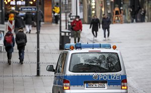 Police controls a main shopping street in Essen, Germany, for people wearing mandatory medical masks during the lockdown due to the COVID-19 pandemic on Tuesday, Feb. 2, 2021