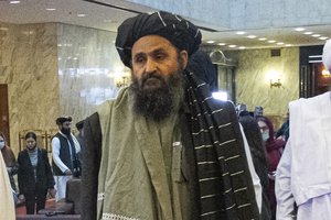 In this March 18, 2021, file photo, Taliban co-founder Mullah Abdul Ghani Baradar, arrives with other members of the Taliban delegation for an international peace conference in Moscow, Russia. Baradar's biography charts the Taliban's long journey from a pious but brutal Islamic militia to an insurgency that battled the U.S. for two decades, ultimately returning to power through pragmatic diplomacy and military might