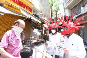 Red Cross supporters wearing red spiky accessories as Coronavirus helmet take out a COVID-19 awareness campaign,in Jammu, India, 02 June 2021.