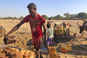 Men dig for water in the dry Mandrare river bed, in Madagascar, Monday, Nov. 9, 2020