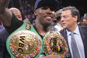 Jermall Charlo poses with his championship belts after beating Juan Macias Montiel in a WBC middleweight world championship boxing match Saturday, June 19, 2021, in Houston.