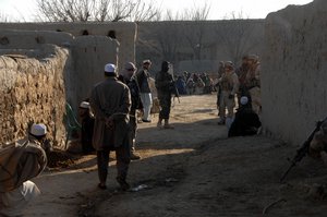 Coalition forces, in conjunction with Afghan National Army commandos, conduct a cordon and search operation in eastern Afghanistan Dec. 18, 2007, to detain and question individuals with suspected ties to the Taliban insurgency. 