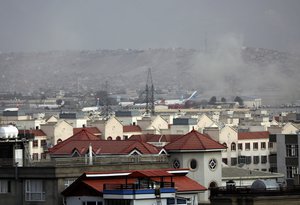 Smoke rises from explosion outside the airport in Kabul, Afghanistan, Thursday, Aug. 26, 2021. The explosion went off outside Kabul’s airport, where thousands of people have flocked as they try to flee the Taliban takeover of Afghanistan.