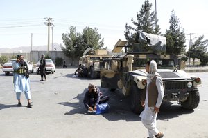 Taliban fighters stand guard outside the airport after yesterday’s deadly attacks outside the airport in Kabul, Afghanistan, Friday, Aug. 27, 2021.