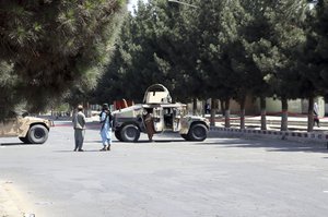 Taliban fighters stand guard near an evacuation control checkpoint on the perimeter of the Hamid Karzai International Airport, in Kabul, Afghanistan, Friday, Aug. 27, 2021.