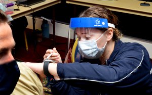 JACKSONVILLE, Fla. (March 30, 2021) Hospitalman Marissa Salomon administers a vaccine to a service member at Naval Hospital Jacksonville's off-site location for COVID-19 vaccines.