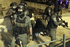 Israeli border police detain a Palestinian outside of the Damascus Gate to the Old City of Jerusalem Tuesday, May 11, 2021