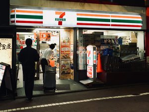 Men entering the 7-eleven convenience store in Shibuya, Japan. Taken on July 2018.