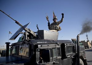 File - An Afghan special forces soldier gestures from the gun turret of a humvee after his unit took over control of an election office after the Taliban launched an assault with a suicide bomber detonating his vehicle in Kabul, Afghanistan, Tuesday, March 25, 2014.