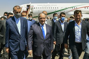 In this photo released by the Syrian official news agency SANA, Syria's Foreign Minister Faisal Mekdad, center, receives Iran’s new Foreign Minister Hossein Amir-Abdollahian, left, in Damascus, Syria, Sunday Aug. 29, 2021. Syria's foreign minister says the "thunderous defeat" by the United States in Afghanistan will lead to similar defeats for American troops in Syria and other parts of the world.