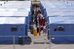 Afghan refugees in an Italian Red Cross refugee camp, in Avezzano, Italy, Tuesday, Aug. 31, 2021. This quarantine camp in Abruzzo, central Italy, where 1,250 migrants are hosted, is expected to close in a week as the quarantine expires and they are moved to other structures to apply for asylum.