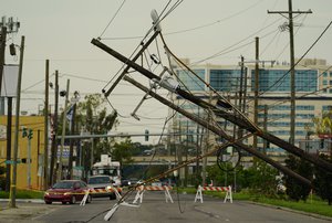 Vehicles are diverted around utility poles damaged by the effects of Hurricane Ida, Tuesday, Aug. 31, 2021, in New Orleans. New Orleans is without power which may last for several weeks.