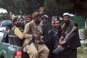 Taliban fighters arrive inside the Hamid Karzai International Airport after the U.S. military's withdrawal, in Kabul, Afghanistan, Tuesday, Aug. 31, 2021