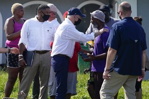 President Joe Biden talks as he tours a neighborhood impacted by Hurricane Ida, Friday, Sept. 3, 2021, in LaPlace, La.