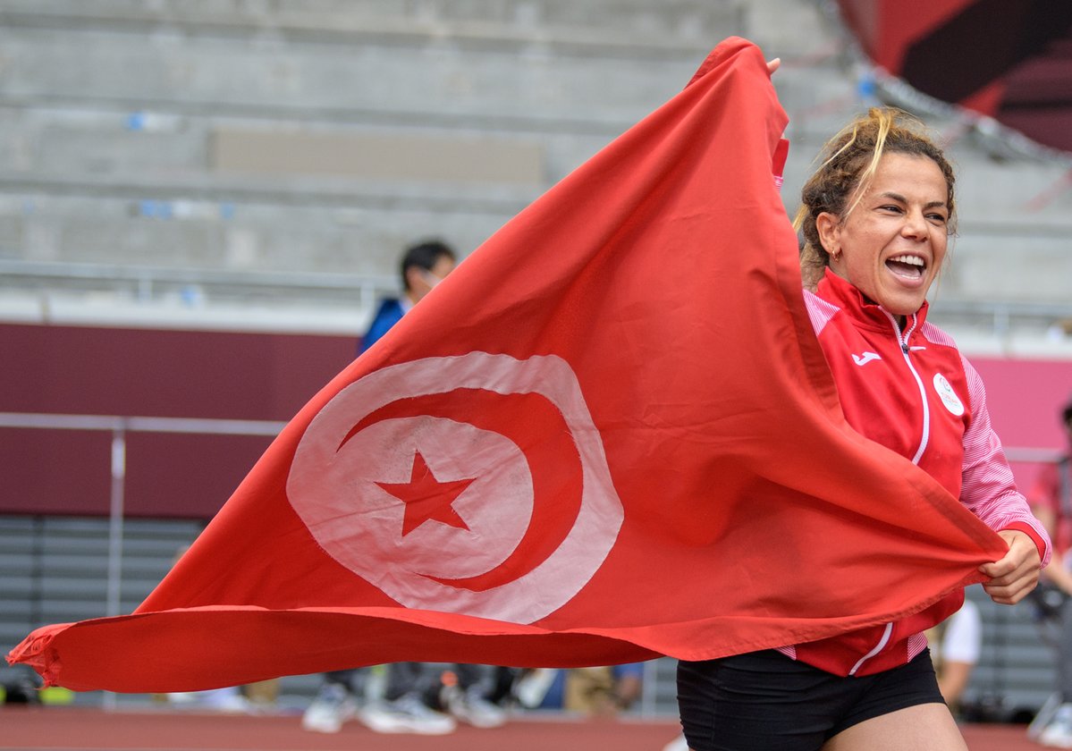 Winner of the Women's Shot Put F41 Raoua Tlili TUN with her national flag at The Olympic Stadium. Tokyo 2020 Paralympic Games.