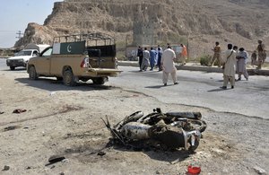 Security officials examine the site of suicide bombing in a checkpoint on the outskirts of Quetta, Pakistan, Sunday, Sept. 5, 2021.