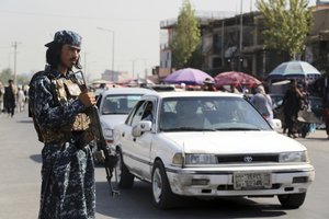 Taliban fighter stand guards in the city of Kabul, Afghanistan, Saturday, Sept. 4, 2021.