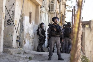 Israeli police move into position during clashes with protesters after a shop was demolished by the municipality, in the Silwan neighborhood of east Jerusalem, Tuesday, June 29, 2021