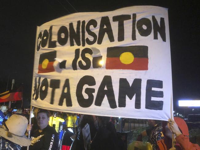 A group of indigenous protesters block a Gold Coast road, bringing a temporary halt to the Queen's Baton Relay before the opening ceremony at Carrara Stadium. Picture: AP Photo/John Pye