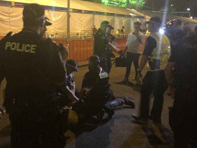 Aboriginal protesters are arrested by police during the Commonwealth Games opening ceremony. Picture: Britt Ramsey